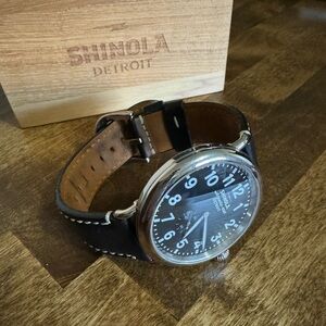 Black Shinola 47mm Runwell with black and brown wrist strap.